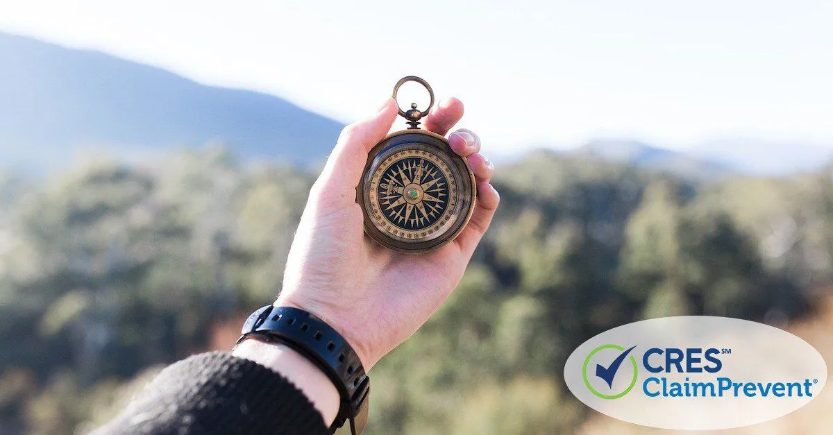 man holding compass in mountains