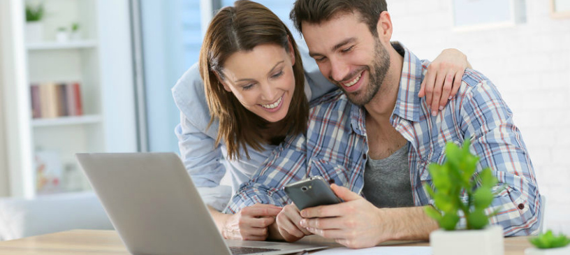 millennial couple on laptop