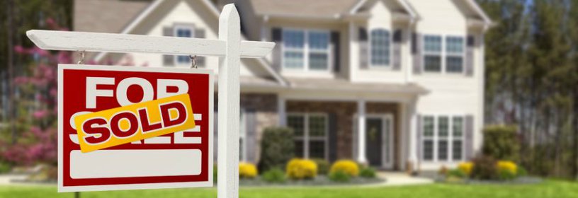 House with sold sign in front of it