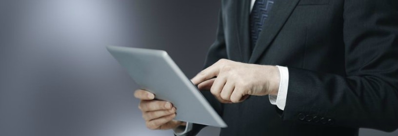 man in suit on tablet