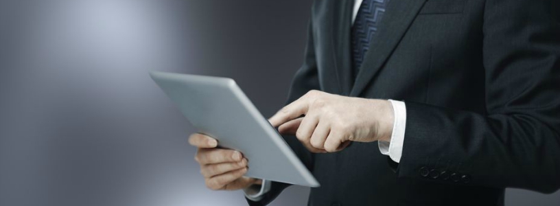 man in suit on tablet