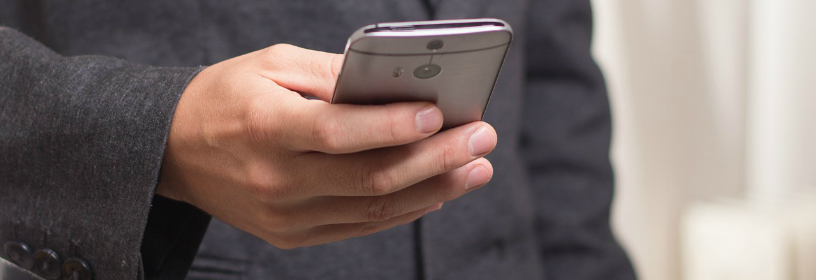 Business man checking email on cell phone