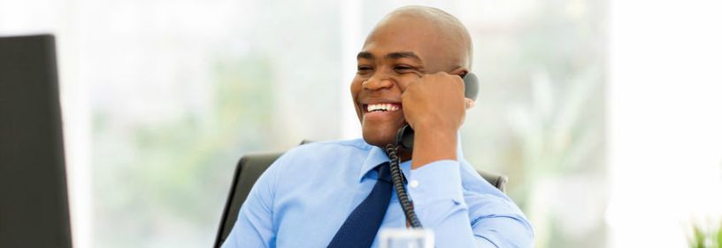 Man sitting at desk on the phone