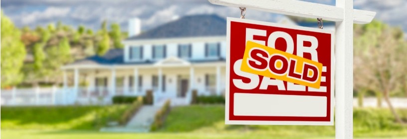 House with Sold sign in front of it