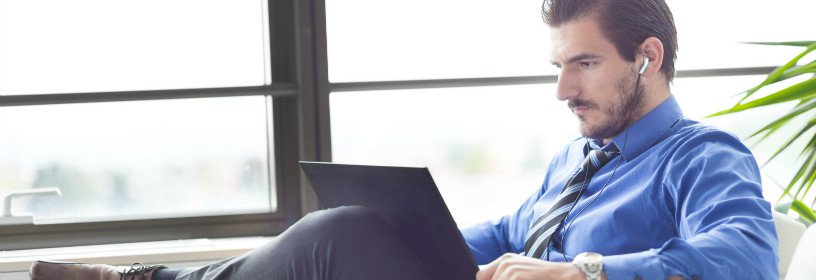 Man listening to tablet with earbuds in