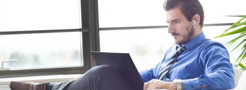 Man listening to tablet with earbuds in