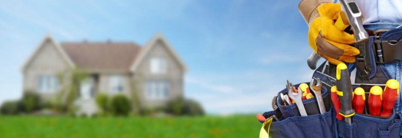 Man with toolbet and house in background