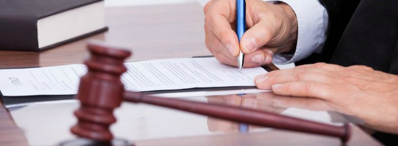 Gavel and judge signing document