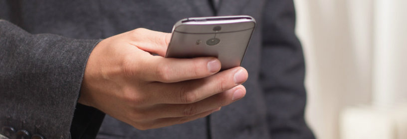 Man checking email on cell phone