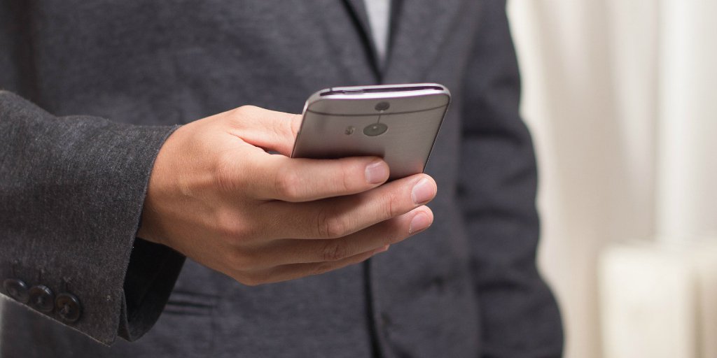 Man checking email on cell phone