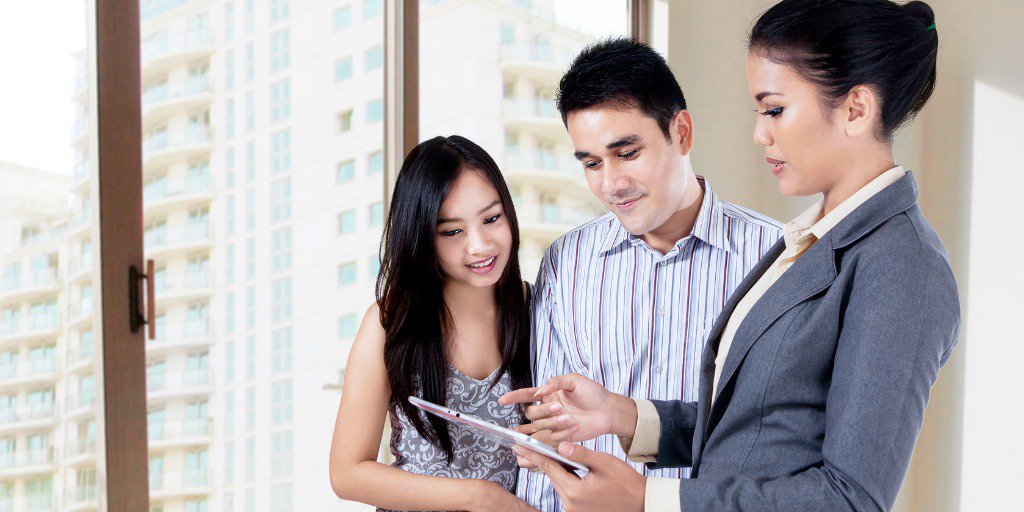 Couple looking at MLS on tablet with Agent