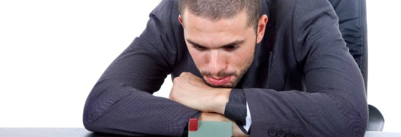 man staring blankly at model house