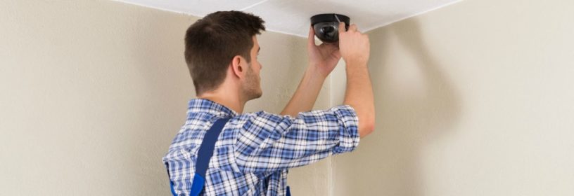 man installing home video surveillance in residence