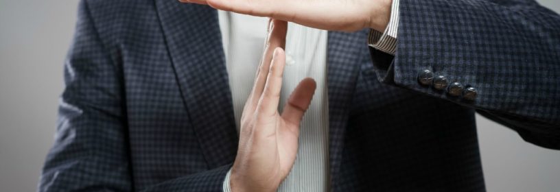 man making time out sign with hands