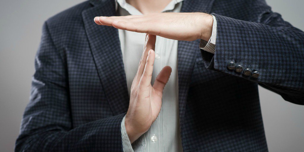 man making time out sign with hands