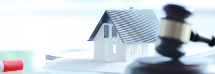 model of house next to gavel