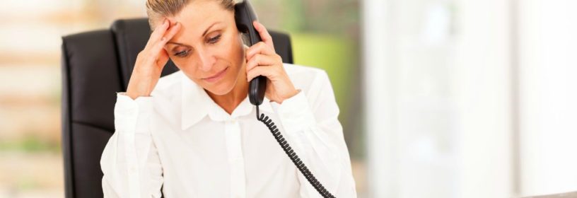 woman on phone stressed about possible real estate lawsuit