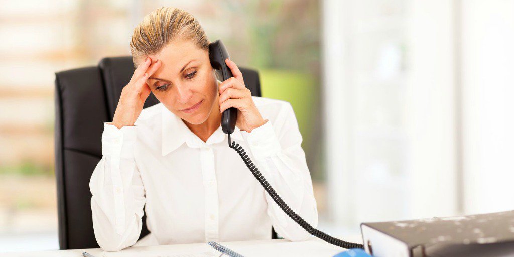 woman on phone stressed about possible real estate lawsuit