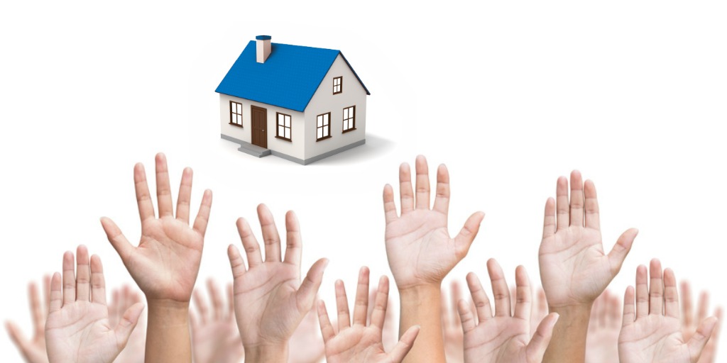 multiple hands raised reaching for house