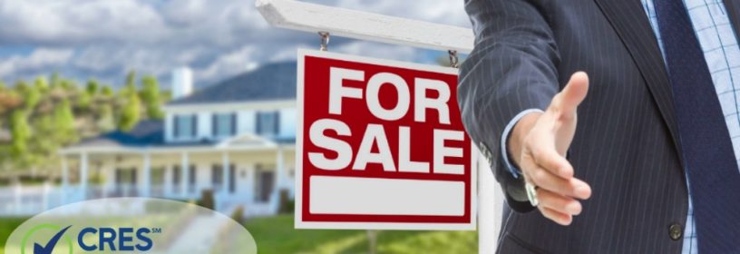 male agent shaking hand in front of house