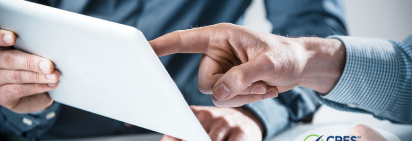 two businessman reviewing information on a tablet