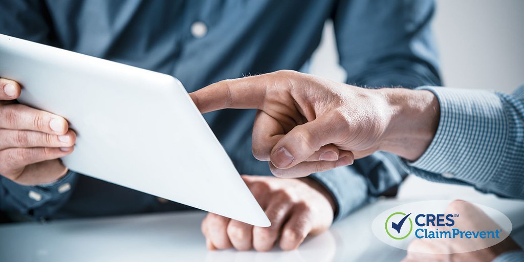 two businessman reviewing information on a tablet