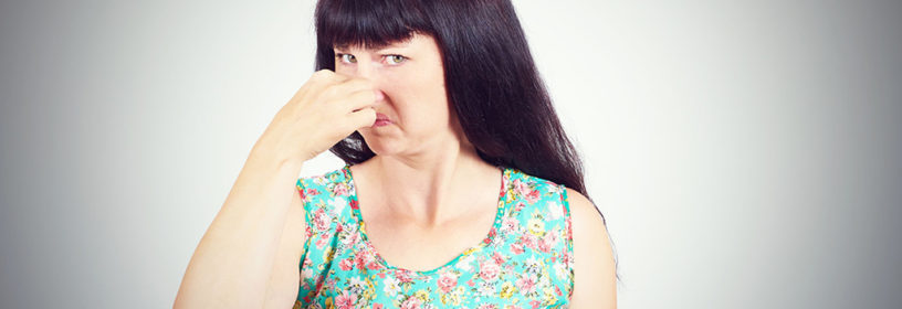 woman pinching nose at bad smell