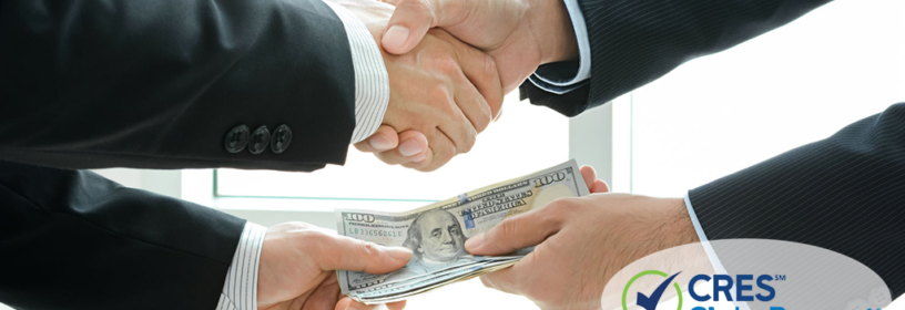 business men shaking hands in exchange for money