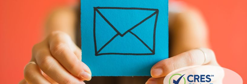 woman holding post-it note with envelope icon representing email marketing