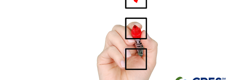 hand holding red marker placing a red check mark in a black outlined box