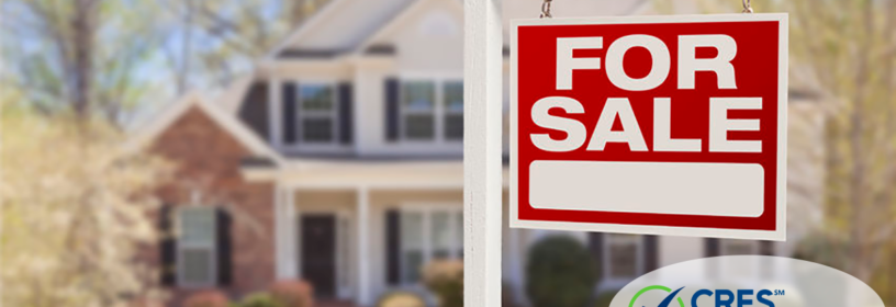 real estate for sale sign in front yard of house