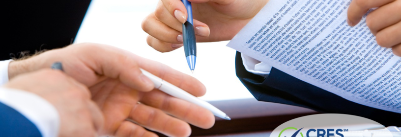 Attorneys with contract and pens in hand