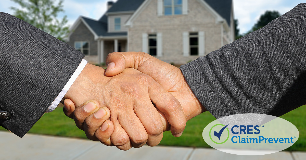 2 men shaking hands in front of house