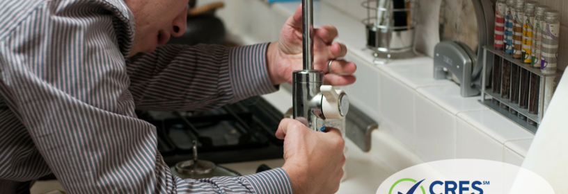 man fixing sink