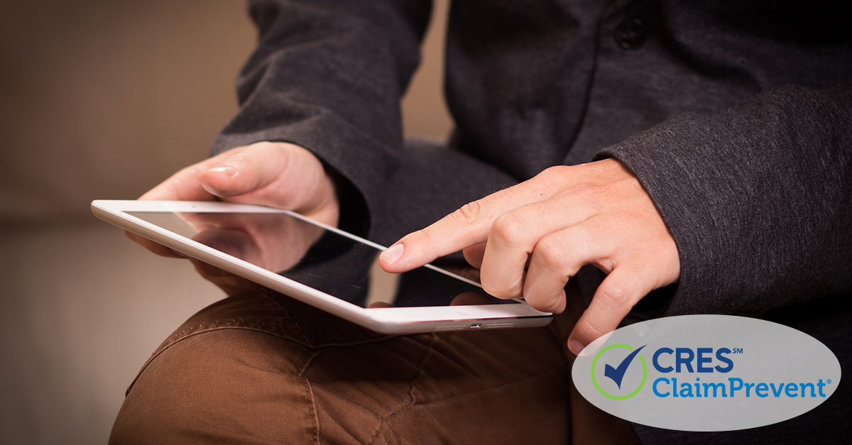 Man signing a document on a tablet