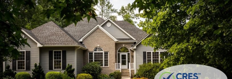 Nice tan and gray brick sided house with walkway leading up to door