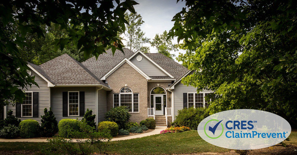 Nice tan and gray brick sided house with walkway leading up to door