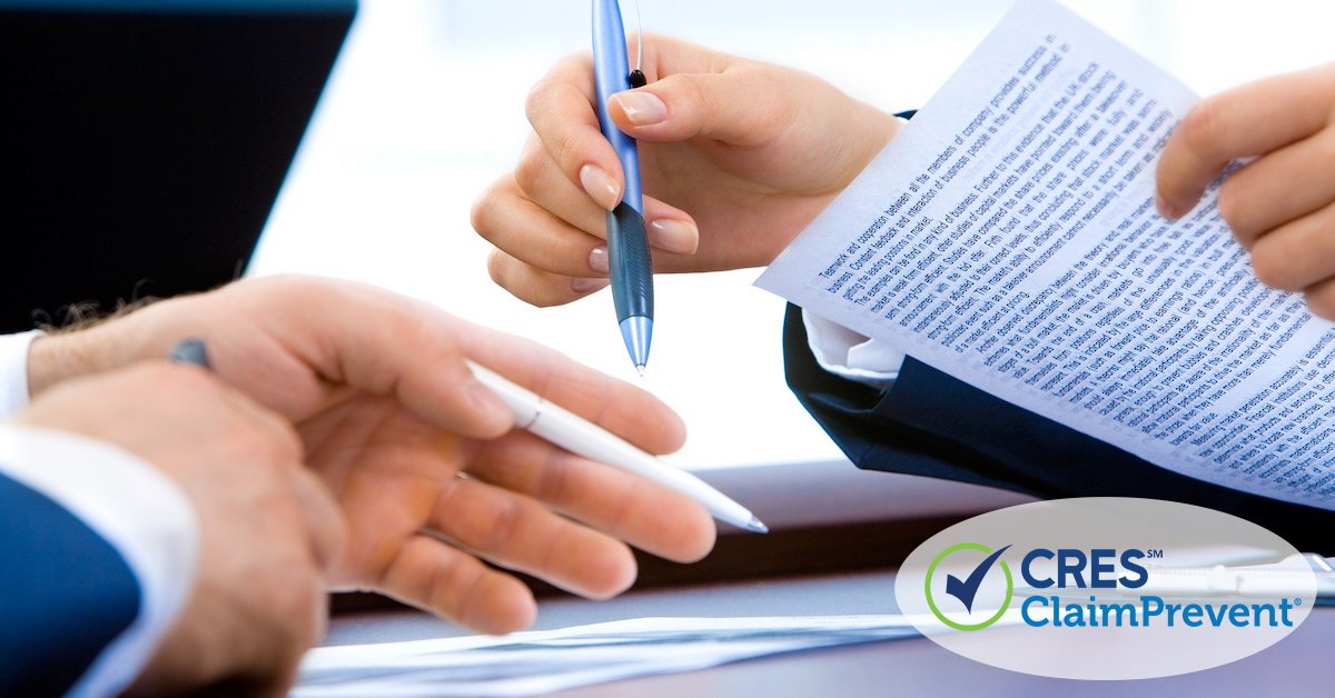 2 sets of male hands looking at legal documents with pen in hand