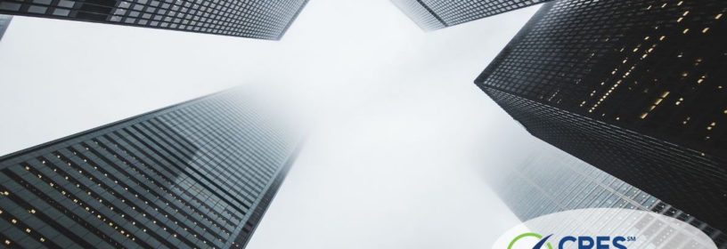 view looking up towards sky through four skyscraper buildings