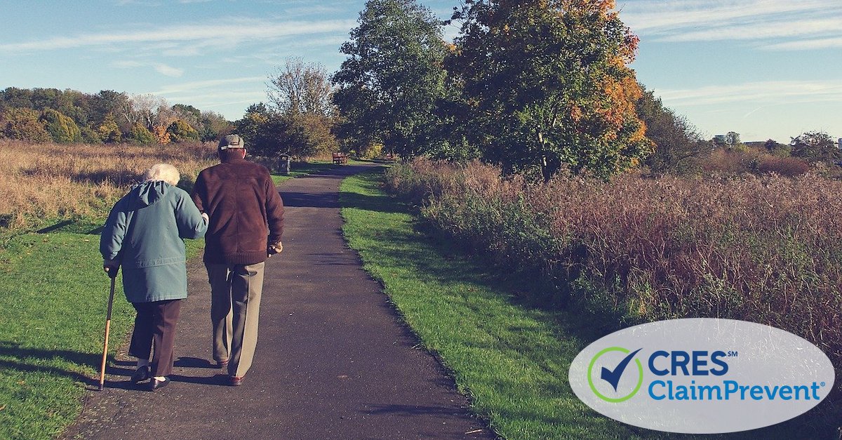 senior man and woman walking down sidewalk