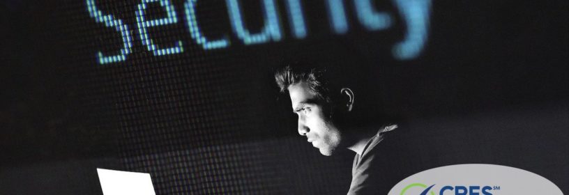man at laptop in the dark with the word security in background