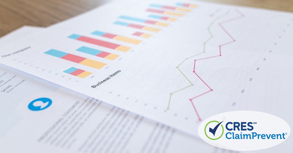 paperwork on desk that shows charts and graphs going up and down