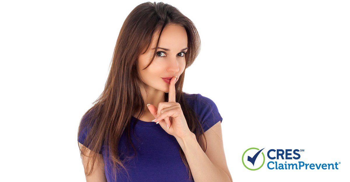 young woman with index finger in front of mouth representing shh