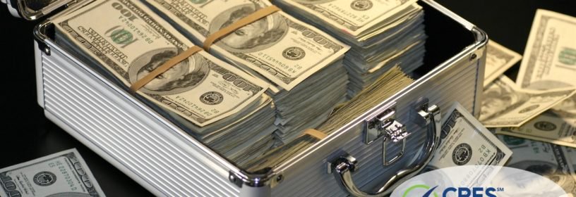 briefcase full of American hundred dollar bills and piles of cash around it