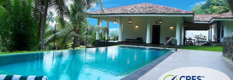 backyard of house with inground pool and palm trees