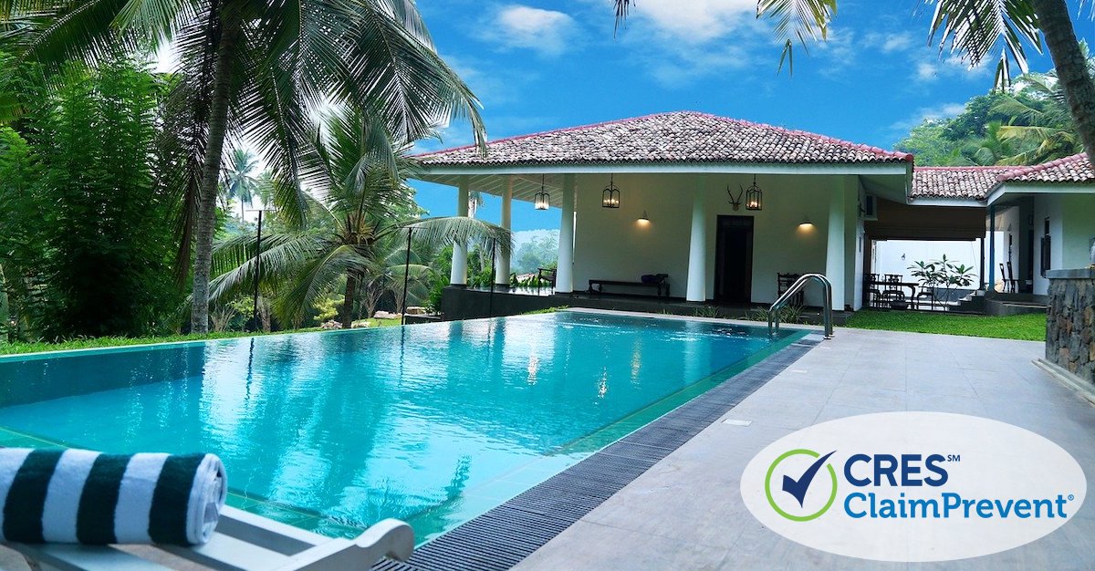 backyard of house with inground pool and palm trees