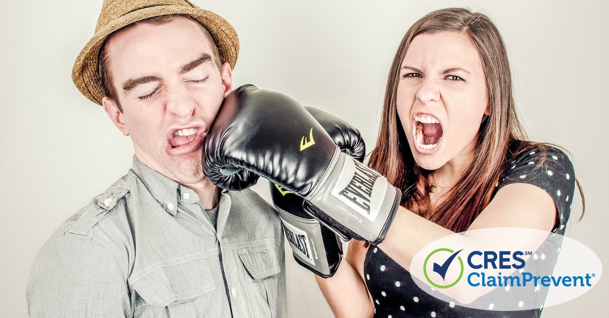 man getting punched by woman with boxing glove on