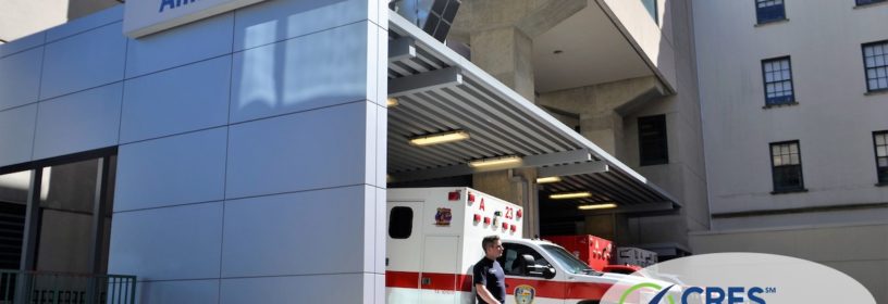 hospital with ambulance parked next to the building