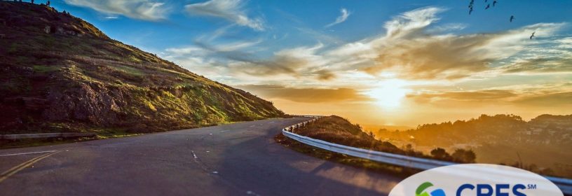 winding road around mountain leading to sunshine