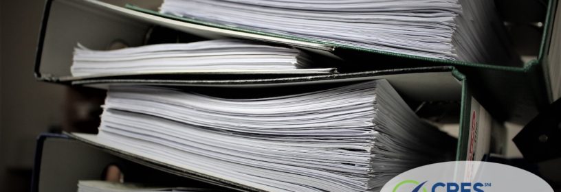 stack of binders full of documents